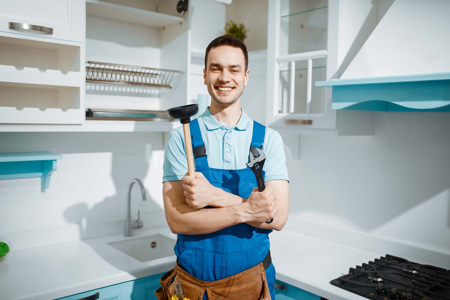 cheerful-male-plumber-holds-wrench-and-plunger-resize.jpg